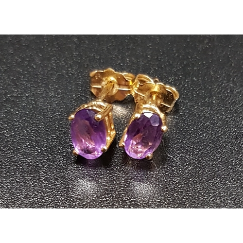 196 - AMETHYST STUD EARRINGS
the oval cut amethysts in unmarked gold and with fourteen carat gold butterfl... 