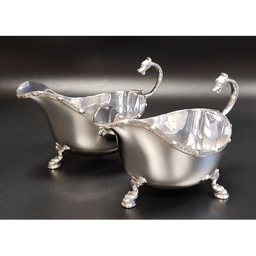 209 - PAIR OF EDWARD VIII SILVER SAUCE BOATS
with serpent scroll handles, raised on three serpent supports... 