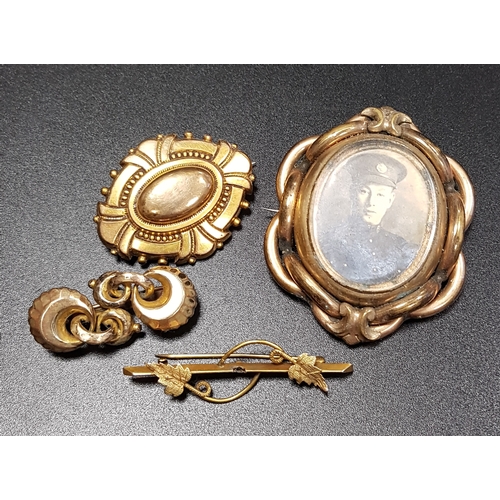 163 - FOUR VICTORIAN AND EDWARDIAN PINCHBECK BROOCHES
including a double sided glass locket example, and a... 