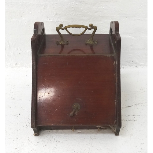 486 - EDWARDIAN COAL SCUTTLE
with a brass shaped carry handle and pierced shaped sides above a slanting li... 