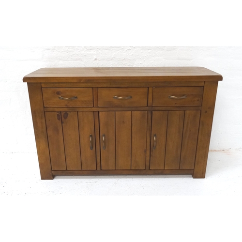 510 - STAINED PINE SIDE CABINET
with a plank top above three frieze drawers with three panelled cupboard d... 