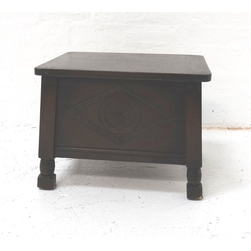 527 - STAINED OAK SEWING BOX
with a lift up lid and carved panels, standing on turned supports, 50cm wide