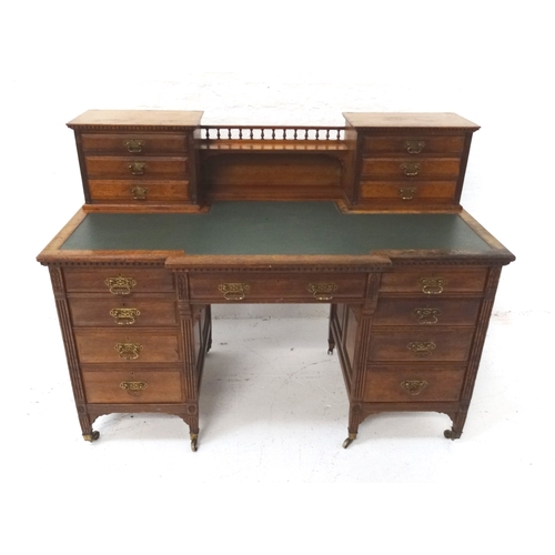 528 - EDWARDIAN MAHOGANY BREAKFRONT KNEE HOLE DESK
with a central gallery and shelf flanked by two section... 