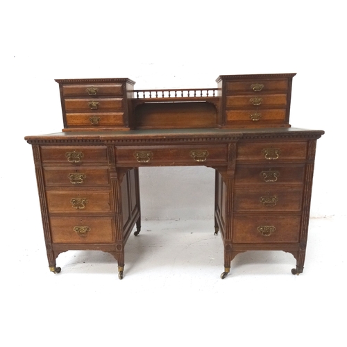 528 - EDWARDIAN MAHOGANY BREAKFRONT KNEE HOLE DESK
with a central gallery and shelf flanked by two section... 