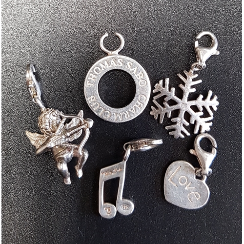 68 - FOUR THOMAS SABO SILVER CHARMS
comprising a snowflake, a cherub, a musical note and a heart; togethe... 