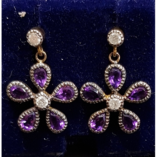 97 - PAIR AMETHYST AND DIAMOND CLUSTER EARRINGS
the flower head drops on each formed with pear cut amethy... 