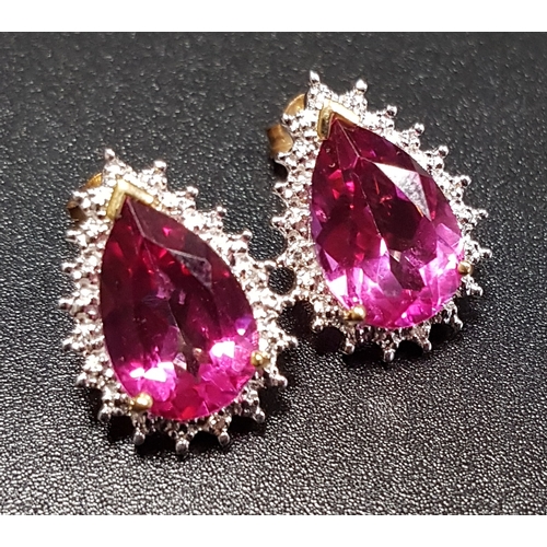 183 - PAIR OF PINK TOPAZ AND DIAMOND EARRINGS
the pear cut pink topaz on each within illusion setting with... 