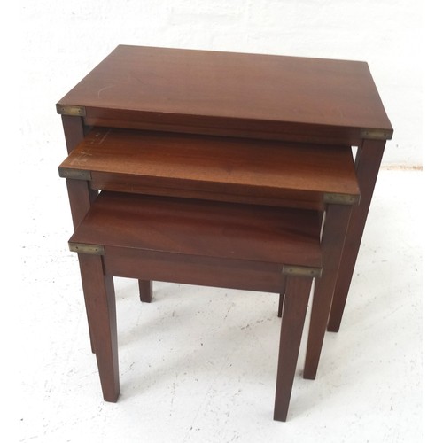 529 - NEST OF MAHOGANY TABLES
with brass banded corners standing on tapering supports, the largest 59cm wi... 