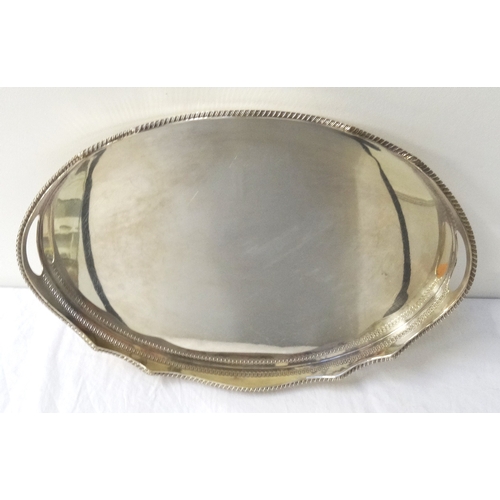 213 - LARGE SILVER PLATED OVAL TRAY
with a wavy rim and pierced handles, raised on squat feet, 50.5cm long