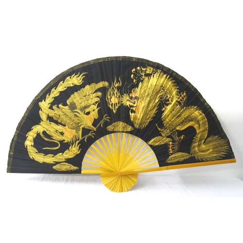 357 - LARGE CHINESE DECORATIVE FAN
with dragon decoration on fabric with wooden sticks