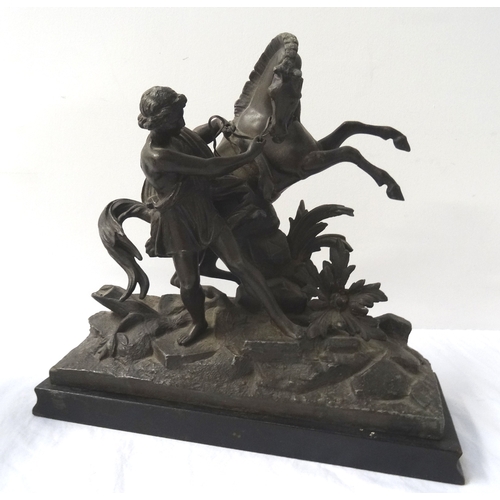 374 - TWO SPELTER FIGURINES
each depicting a man trying to control a rearing horse, raised on ebonised rec... 