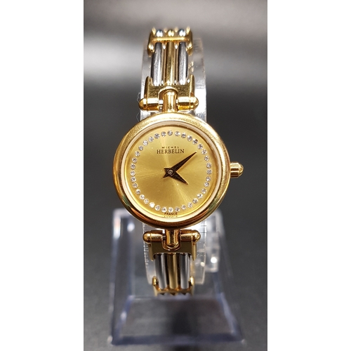 179 - LADIES MICHEL HERBELIN WRISTWATCH
with gilt dial and two tone strap, the backplate numbered 7072.B