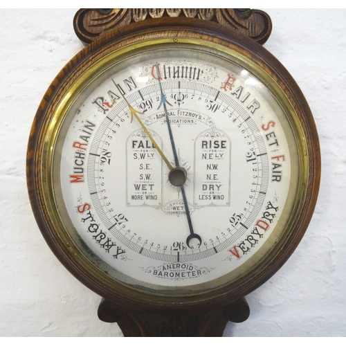 364 - ADMIRAL FITZROY'S ANEROID BAROMETER
in a carved oak case with a thermometer above a circular dial, 9... 