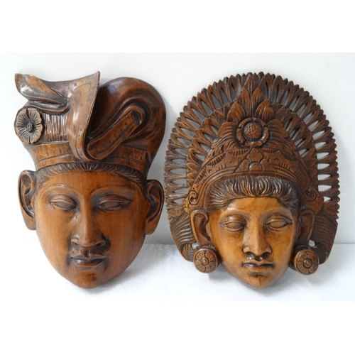 369 - PAIR OF BALINESE CARVED MASKS
depicting a male and female with traditional headwear (2)