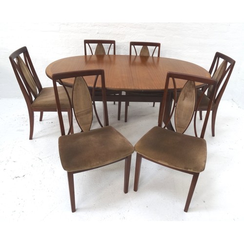 478 - G PLAN MAHOGANY DINING TABLE
with an oval pull apart top revealing a fold out leaf, standing on shap... 