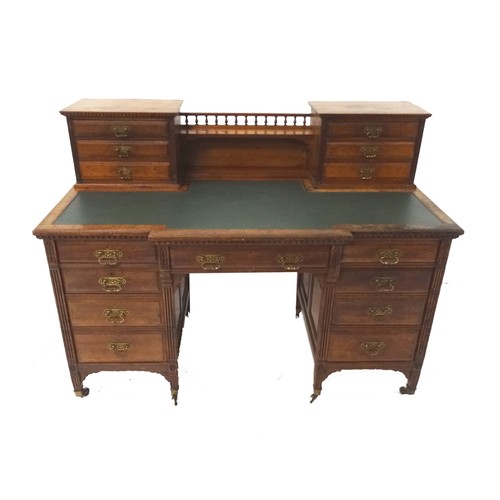 528 - EDWARDIAN MAHOGANY BREAKFRONT KNEE HOLE DESK
with a central gallery and shelf flanked by two section... 