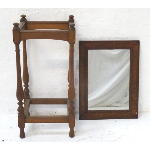 343 - RECTANGULAR OAK FRAMED WALL MIRROR
54.5cm high; together with an oak stick stand of rectangular form... 