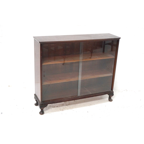 368 - MAHOGANY BOW FRONT BOOKCASE
with a pair of glass sliding doors revealing three shelves, standing on ... 