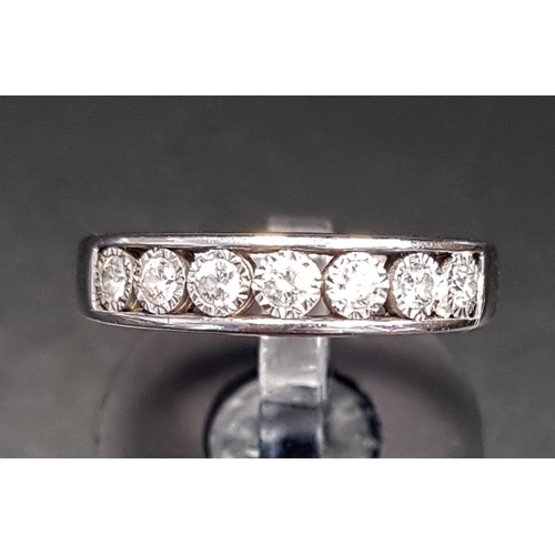 83 - DIAMOND HALF ETERNITY RING 
the channel illusion set diamonds totalling approximately 0.25cts, in ni... 