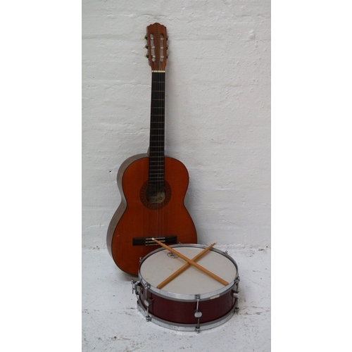 285 - SUZUKI ACOUSTIC GUITAR
number 3065; together with a Gigster snare Drum with an Evans Uno 58 1000 dru... 