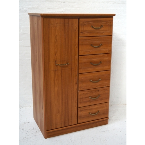 334 - ALSTONES OAK COMPACTUM
with a bow front moulded top above a narrow wardrobe door opening to reveal h... 