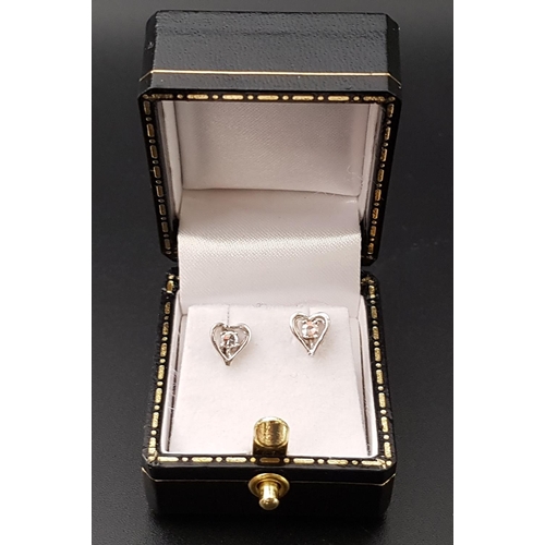 81 - PAIR OF DIAMOND SET HEART SHAPED STUD EARRINGS
in fourteen carat white gold, the diamonds totalling ... 