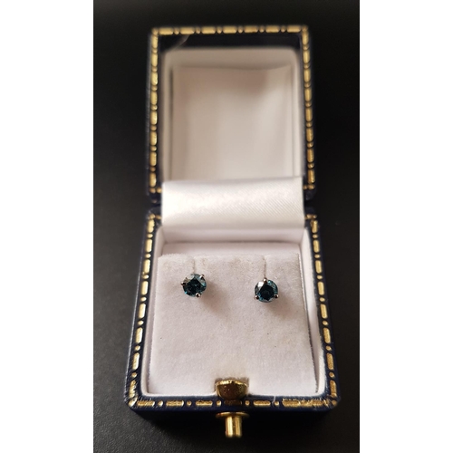 85 - PAIR OF BLUE DIAMOND STUD EARRINGS
in eighteen carat white gold, the round brilliant cut diamonds to... 