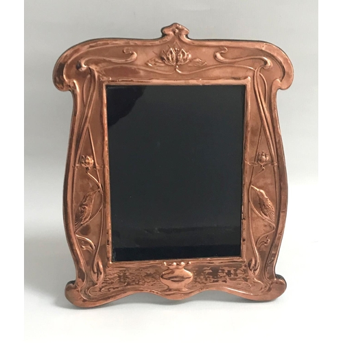 262 - ART NOUVEAU STYLE COPPER PHOTOGRAPH FRAME
the shaped frame with relief bird and scroll decoration, o... 