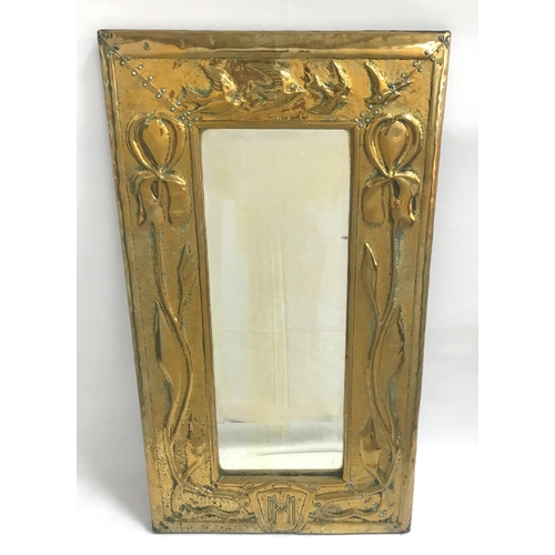 352 - ARTS AND CRAFTS BRASS WALL MIRROR
with an oblong embossed frame decorated with birds and flowers and...
