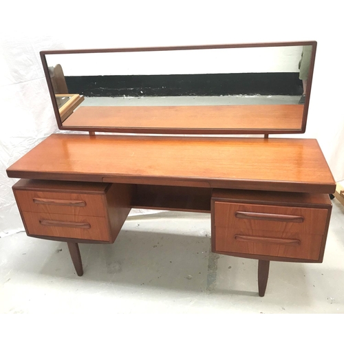 318 - G PLAN TEAK KNEEHOLE DRESSING TABLE
with an oblong mirror back above a central flush fitting velvet ... 