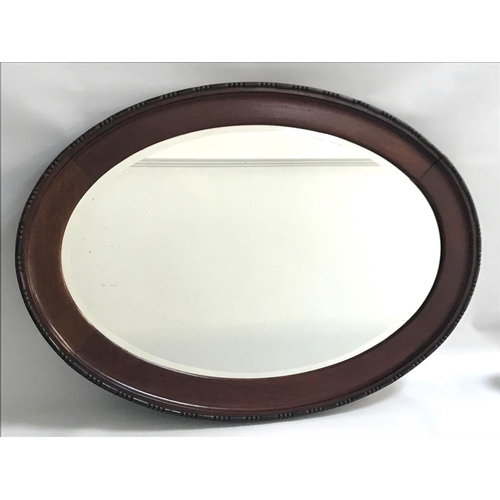 322 - MAHOGANY OVAL WALL MIRROR
with a beveled plate, 87.5cm high