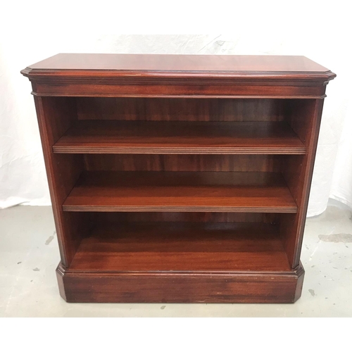 396 - MAHOGANY AND CROSSBANDED BOOKCASE
with a moulded top with canted corners flanking adjustable shelves... 