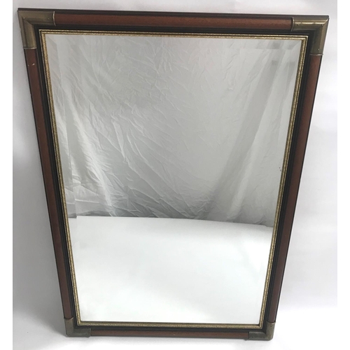 407 - OBLONG WALL MIRROR
with a mahogany effect and brass bound frame with a beveled plate, 65cm x 95cm