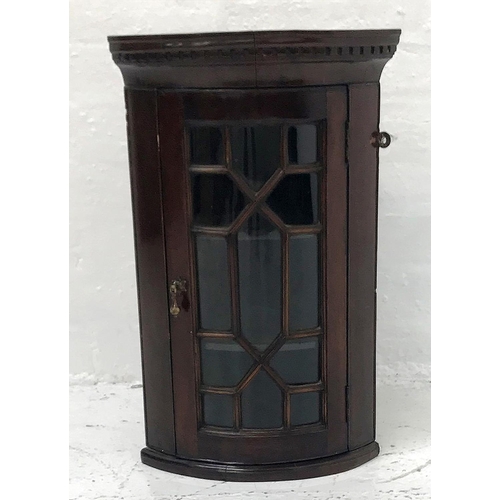 413 - QUEEN ANNE STYLE MAHOGANY BOW FRONT CORNER CABINET
with a moulded dentil cornice above an astragal g... 