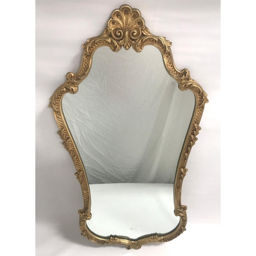 416 - ORNATE GILT METAL WALL MIRROR
with a shaped frame surmounted with a shell, 114cm high