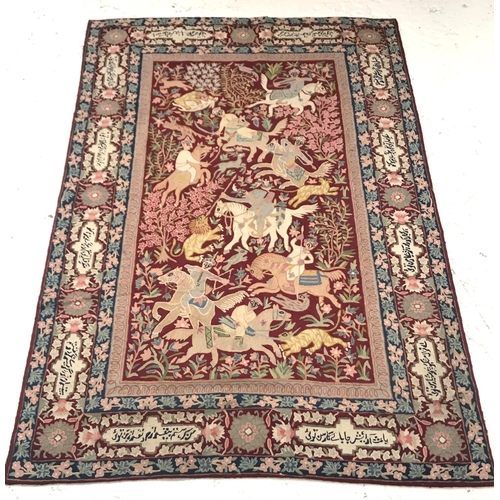 419 - PERSIAN RUG/WALL HANGING
with a claret ground decorated with men on horseback hunting wild animals w... 