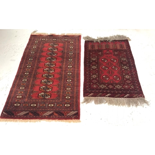 395 - TWO FLOOR RUGS
comprising an Ishfan rug with a red ground and multi lozenge sectional decoration wit... 
