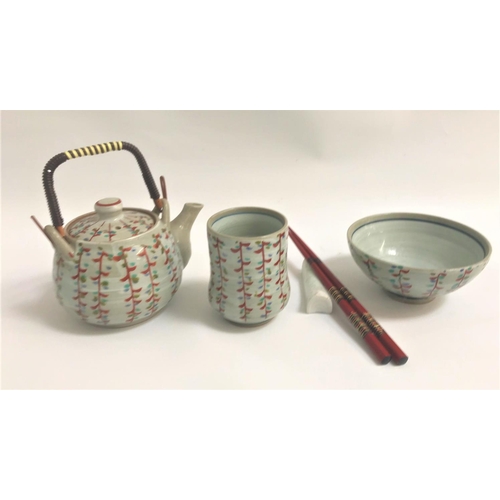 113 - CHINESE TEA POT
with a swing cane handle, matching tea bowl and bowl, all decorated with a grey wash... 