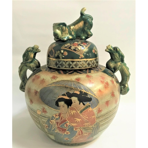 139 - LARGE JAPANESE TWIN HANDLED VASE
with a circular lid decorated with fans and flowers and a dog finia... 