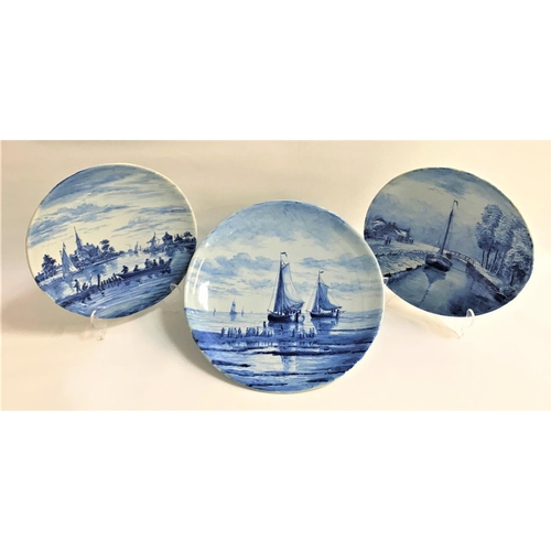 143 - PAIR OF DELFT BLUE AND WHITE PLATES
decorated with canal scenes, 25cm diameter, and a larger Delft c... 