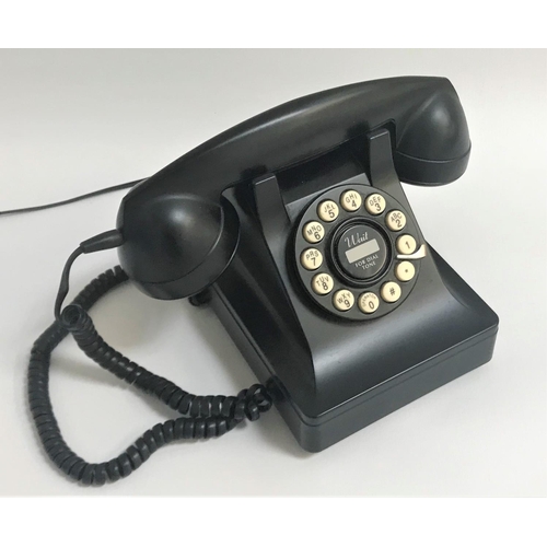 155 - RETRO STYLE BAKELITE TELEPHONE
with a faux circular dial pad with push buttons, the underside with V... 