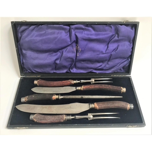 157 - EDWARDIAN DOUBLE CARVING SET
with a sharpening steel, all with antler handles and marked 'Wingfield ... 