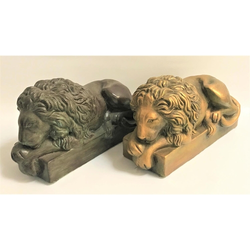 186 - PAIR OF RECUMBENT PLASTER LIONS
on plinth bases, one in a verdigris and one in a gilt finish, 42cm l... 