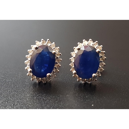 68 - PAIR OF SAPPHIRE AND DIAMOND CLUSTER STUD EARRINGS
the central oval cut sapphire on each approximate... 