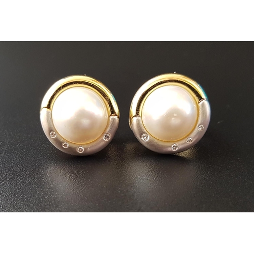 78 - PAIR OF MABE PEARL AND DIAMOND EARRINGS
the central pearl on each in two tone nine carat gold mount,... 