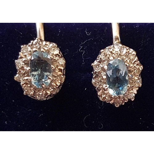 97 - PAIR OF AQUAMARINE AND DIAMOND CLUSTER EARRINGS
the central oval cut aquamarines in diamond surround... 