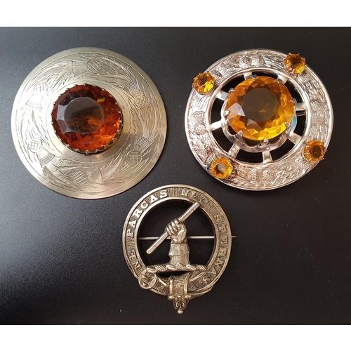 76 - TWO COLOURED GLASS CIRCULAR PLAID BROOCHES
one with engraved thistle decoration, the other with reli... 