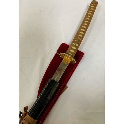 63 - REPRODUCTION JAPANESE SAMURAI SWORD
with a 69.5cm blade and gilt metal tsuba, in an ebonised sheath