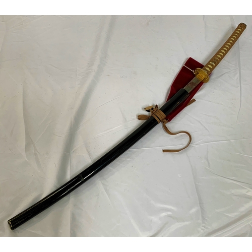 63 - REPRODUCTION JAPANESE SAMURAI SWORD
with a 69.5cm blade and gilt metal tsuba, in an ebonised sheath