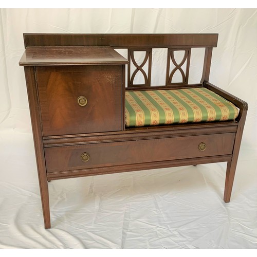 82 - MAHOGANY TELEPHONE SEAT
with a pierced back above a padded seat with a cupboard beside, above a long... 